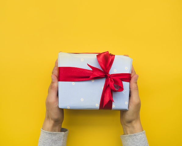 Person holding a wrapped present.