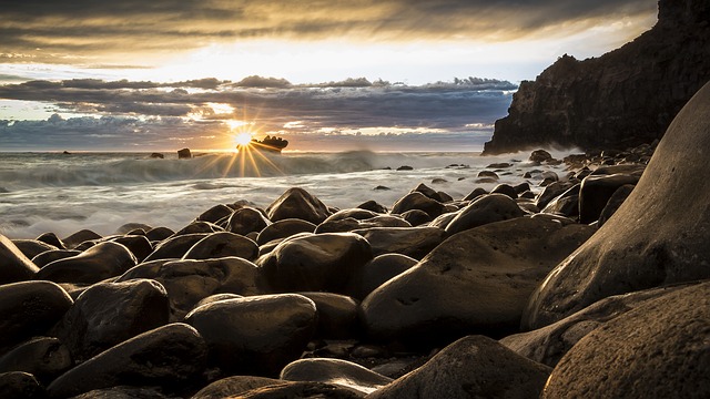 Seascape photo of New Zealand with sun shining through.