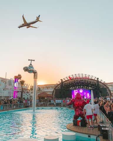 ibiza party with a plane flying over top. 