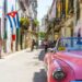 Havana with colorful walls and a pink car.