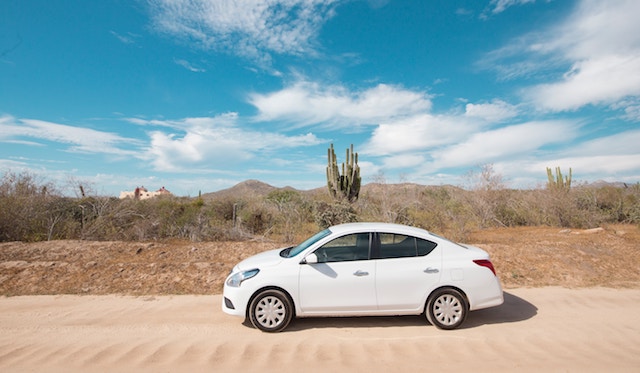 A white car in the desert, rental from a money saving app. 