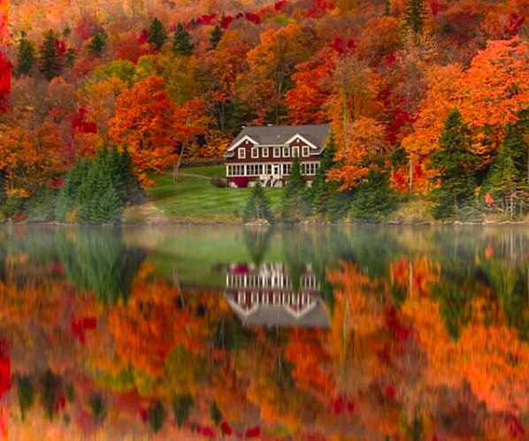 colorful fall foliage reflected on a lake in New Hampshire