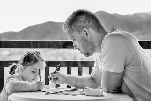 Father doing homework with daughter