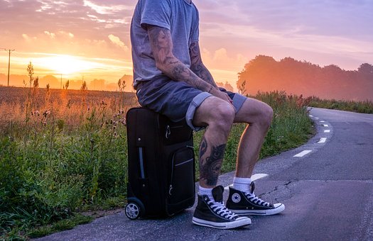 Guy sitting on a suitcase